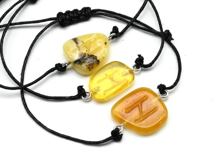 Bracelet with the Hagalaz Rune made of amber 10*17mm on a lace color honey-milk