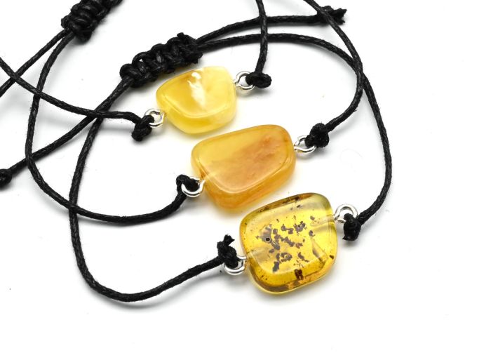 Bracelet with the Rune Vird made of amber 10*17mm on a lace color.honey-milk